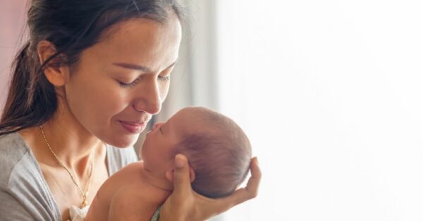 person holding newborn baby