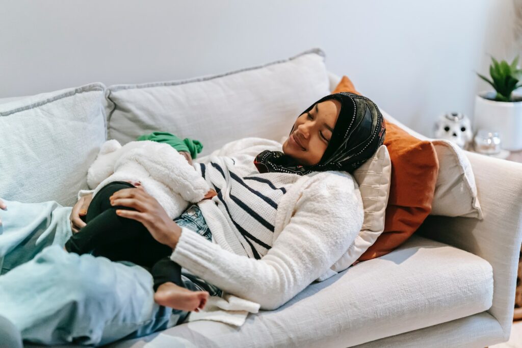 Parent breastfeeding on couch