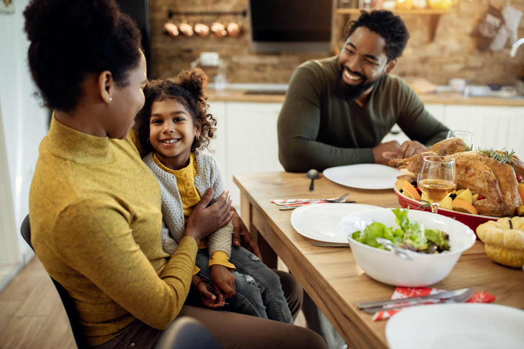 A family enjoys a meal together at the dining table, celebrating time with loved ones.