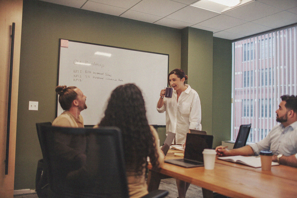 four people meeting around a conference table
