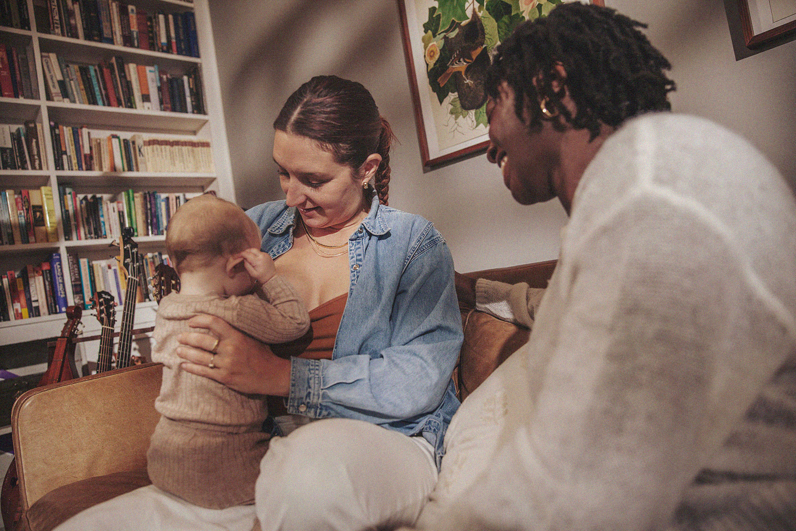 A parent bonding with their baby during a breastfeeding session with an International Board Certified Lactation Consultant offering support.