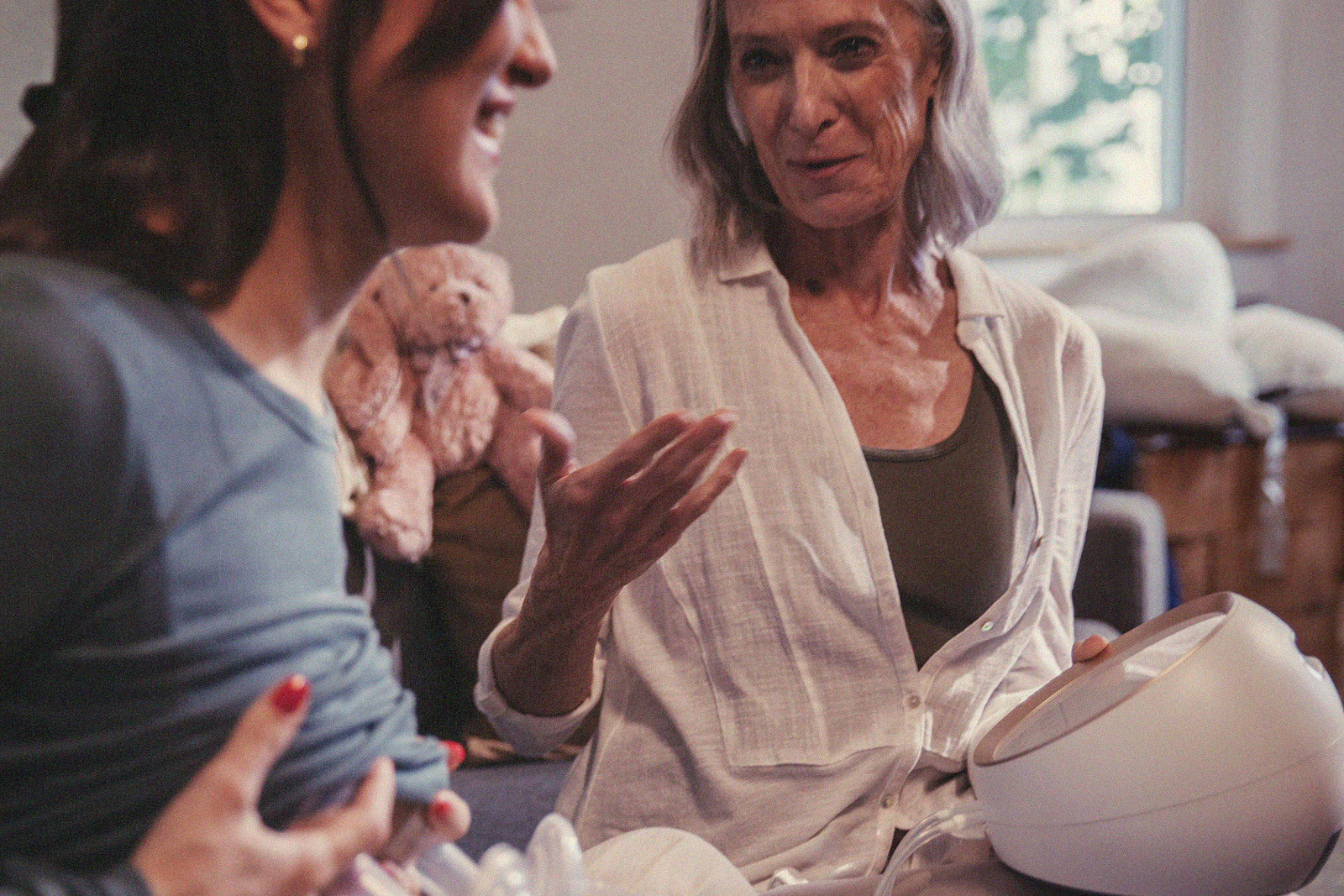 A close-up of a parent using a breast pump while talking to an International Board Certified Lactation Consultant.