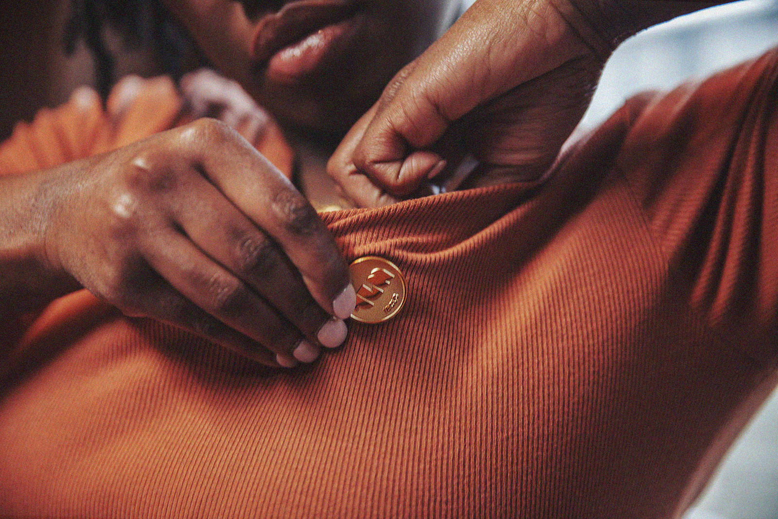 Private practice lactation consultant applies The Lactation Network pin to shirt