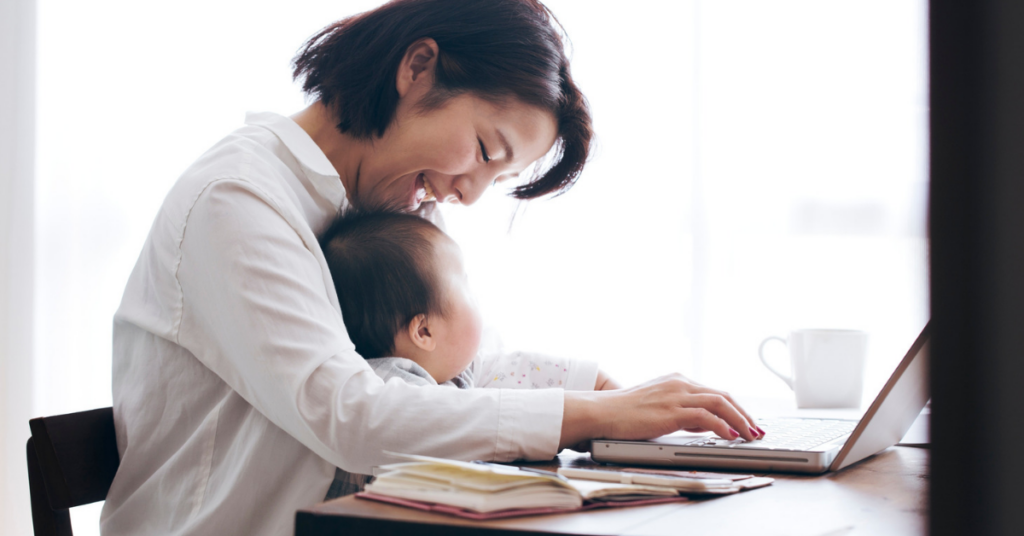 Parent and baby sitting at desk