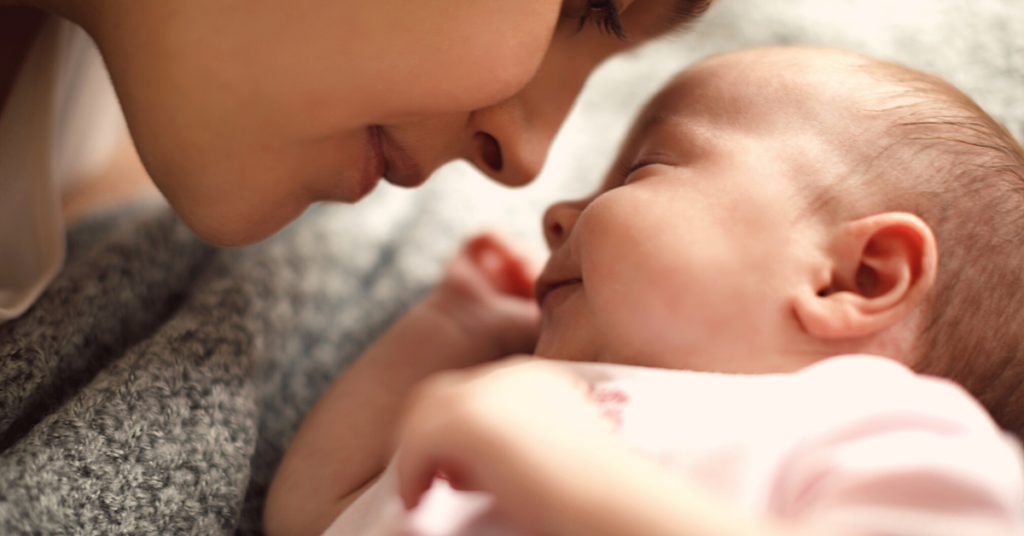 Parent breastfeeding on couch