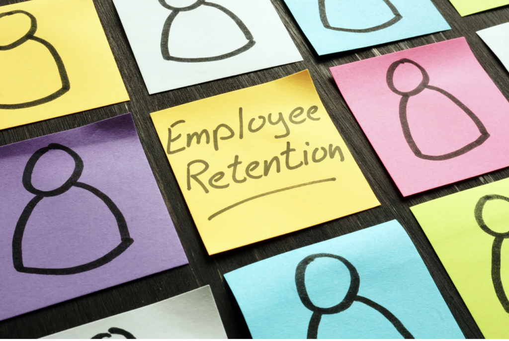 Sticky notes with human figures and one labeled 'Employee Retention,' representing strategies to prevent employee turnover.