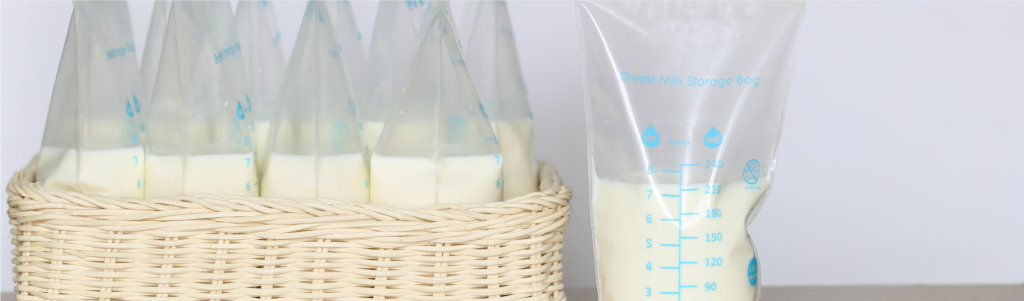 Breast milk storage bags filled with milk, neatly arranged in a woven basket for organized storage.